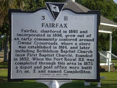 Picture of historical sign of Fairfax, South Carolina with a white wood gazebo in the background.
